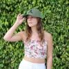 woman-standing-outside-in-front-of-trees-wearing-green-hurley-hat